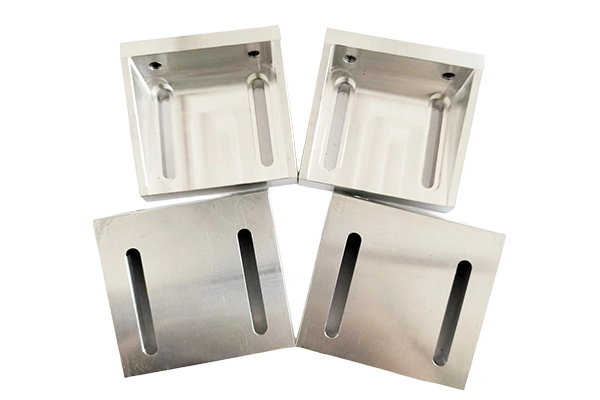 Side-by-side comparison of aluminum and stainless steel CNC machined parts.