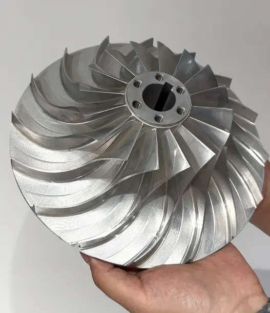 Thin blade precision aluminum impeller showing complex twisted blade geometry during CNC machining